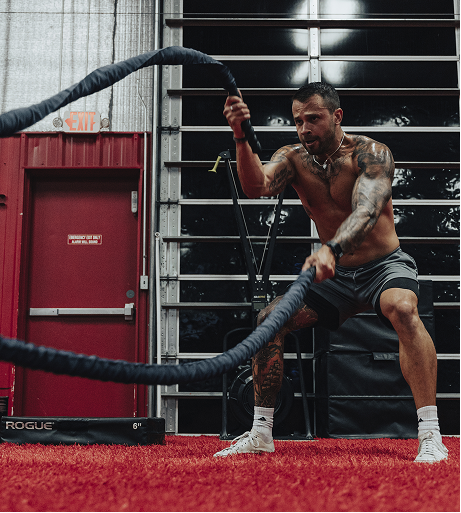 Athlete training with battle ropes